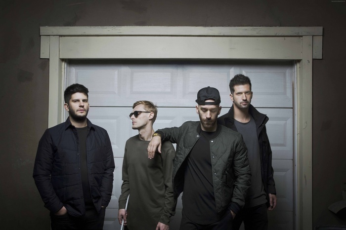 X Ambassadors band members in front of garage door