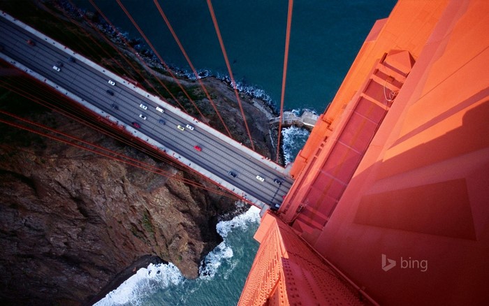 Golden Gate Bridge from above with cars and ocean