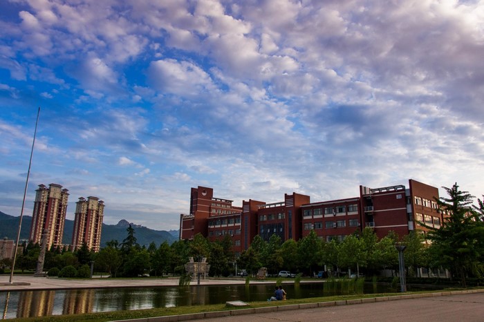 University campus with modern buildings and a pond