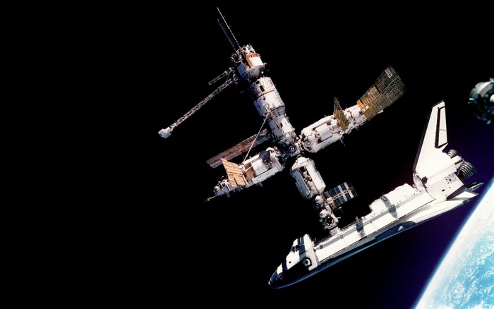Space Shuttle docked with Mir space station above Earth