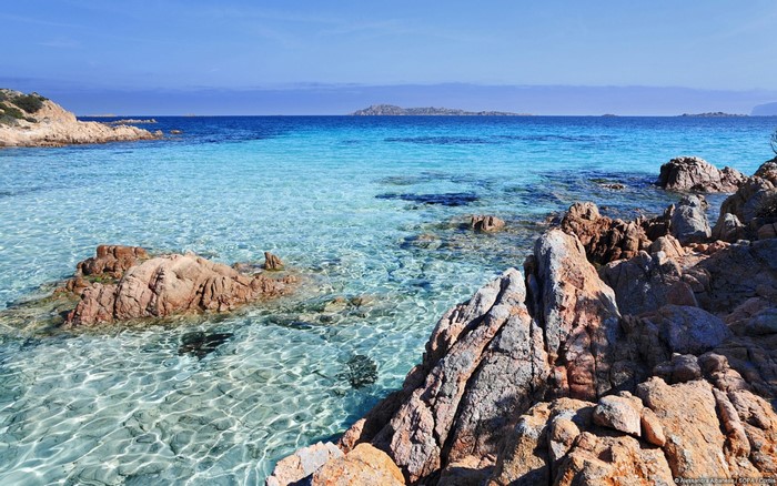 Crystal clear turquoise sea with rocky coastline and islands