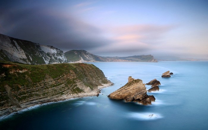 Coastal cliffs and sea stacks at sunrise