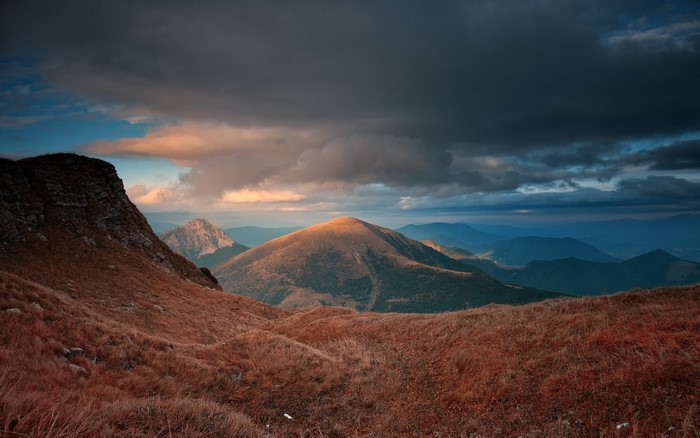 Mountain landscape at sunset with dramatic clouds
