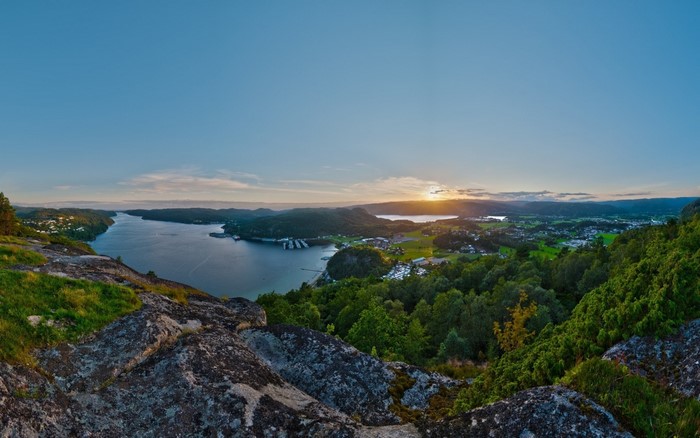 Panoramic view of a bay with hills and sunset