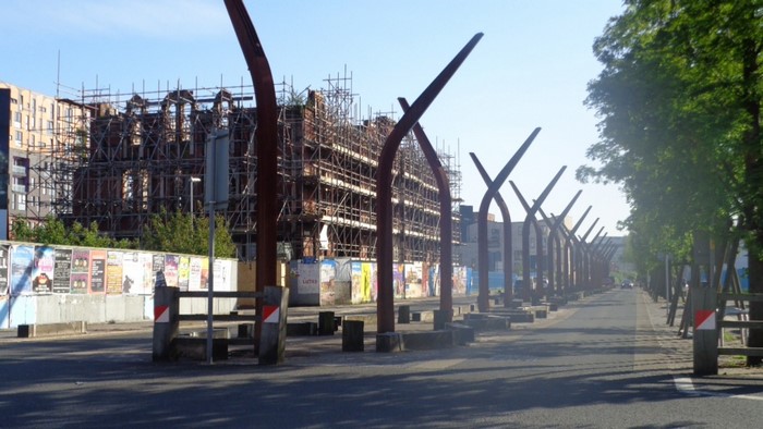 Street with sculptures and building under construction
