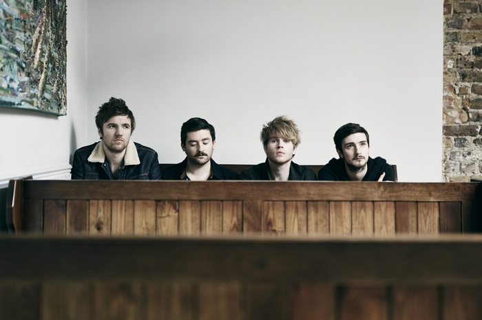 Kodaline band members sitting in pews