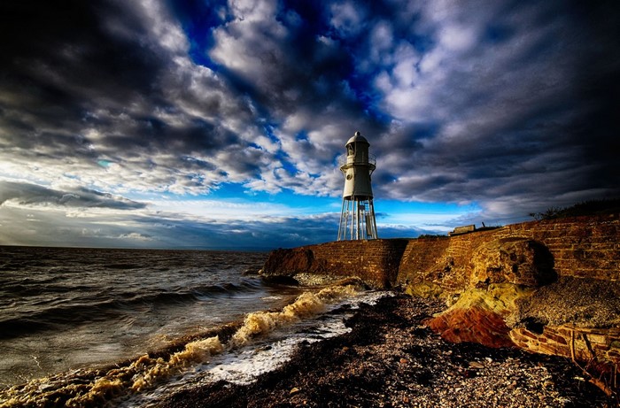 Dramatic Sunset over England Coastal Lighthouse