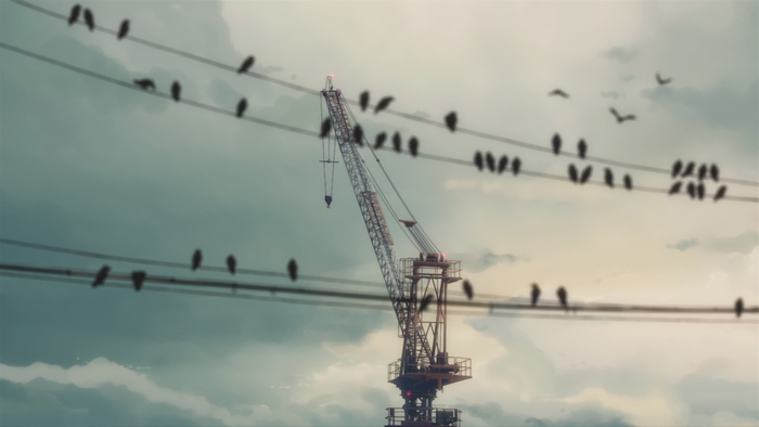 Birds on wires with a crane against cloudy sky