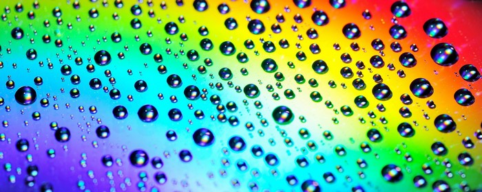 Close up of water drops on a rainbow background