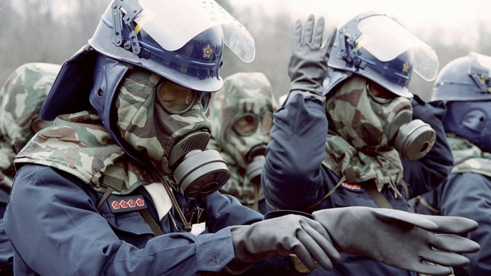 Soldiers in gas masks and riot gear
