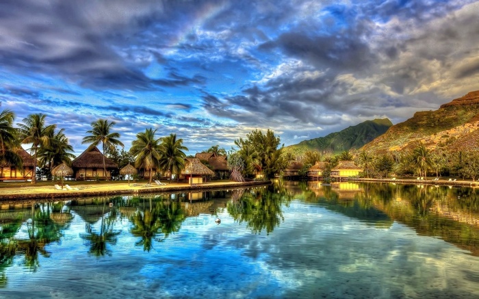 Tropical bungalows on the water with mountains