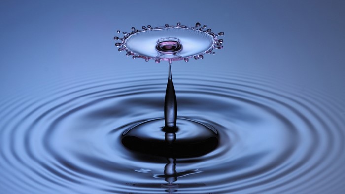 Macro Shot of Water Drop Ripple and Reflection
