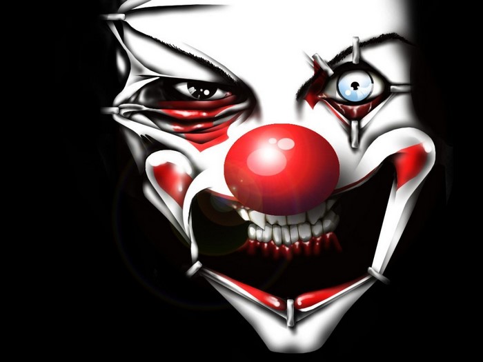 Creepy clown face with red nose and sharp teeth