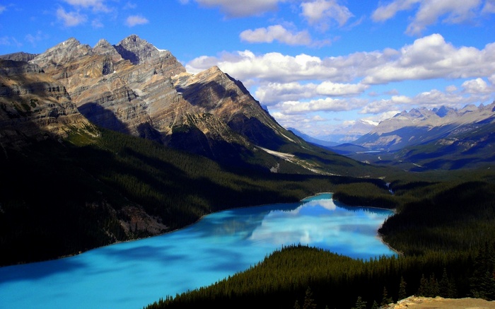 Turquoise lake and mountains under a cloudy sky
