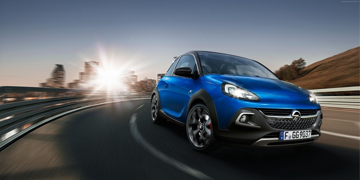 Blue Opel ADAM ROCKS S driving on a road
