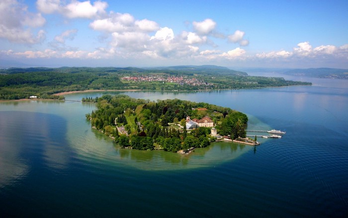Island with buildings and trees on a lake