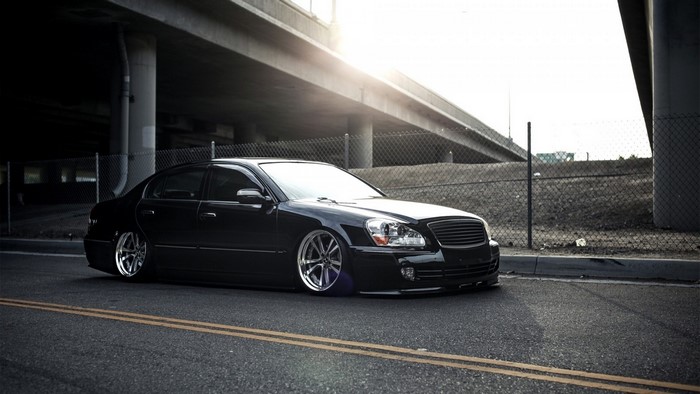 Black sedan with custom rims parked on the street
