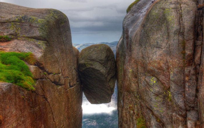 Kjeragbolten boulder wedged between cliffs in Norway