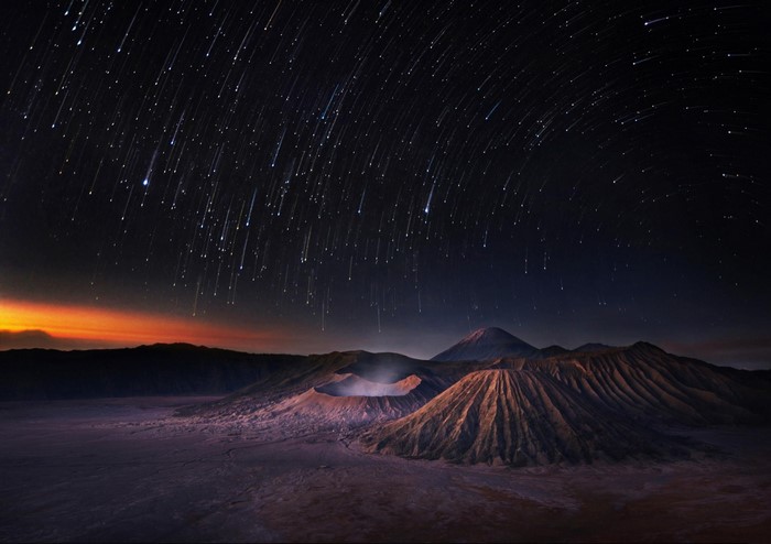 Volcanoes under a meteor shower at night