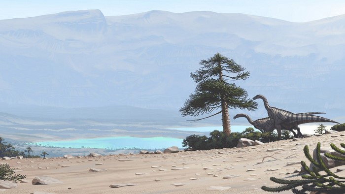 Dinosaurs in a prehistoric landscape with a lake and mountains