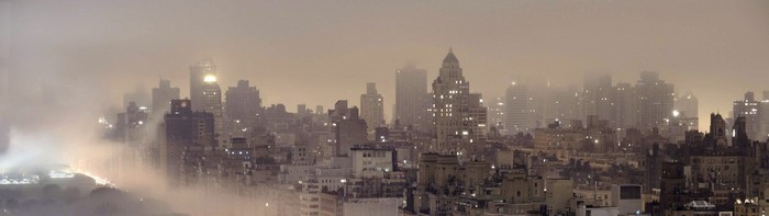 Panoramic cityscape of a foggy metropolis at night