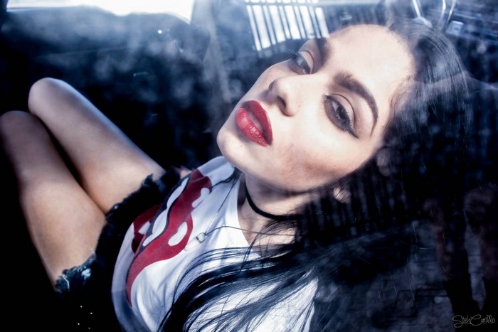 Woman with dark hair and red lipstick
