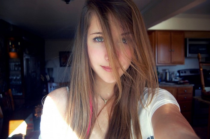 Young woman with long brown hair and blue eyes