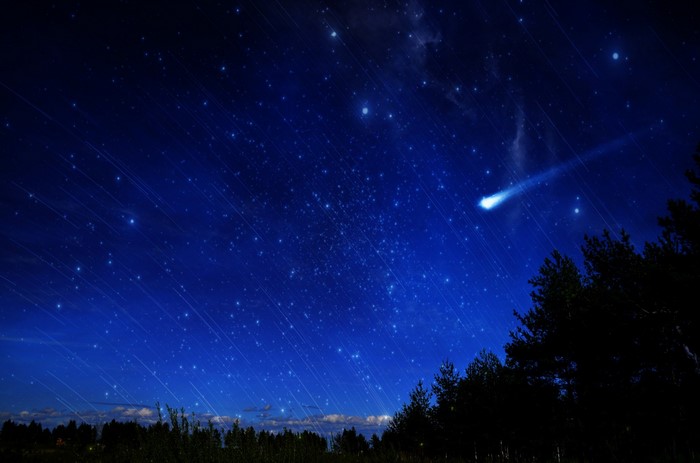 Night sky with a comet and many stars