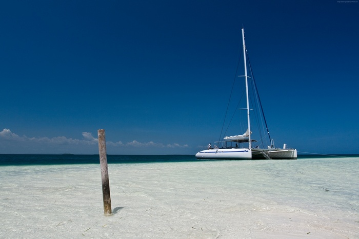 Catamaran anchored in shallow Caribbean waters near Cayo Blanco Island, Cuba