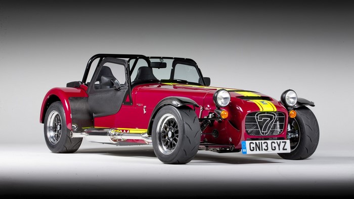 Red Caterham 7 sports car with yellow stripes