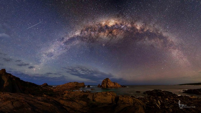 Milky Way over rocky coastline at night