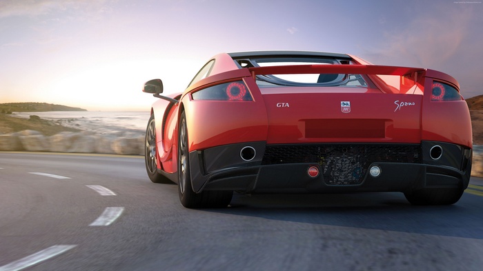 Red GTA Spano supercar driving on a coastal road