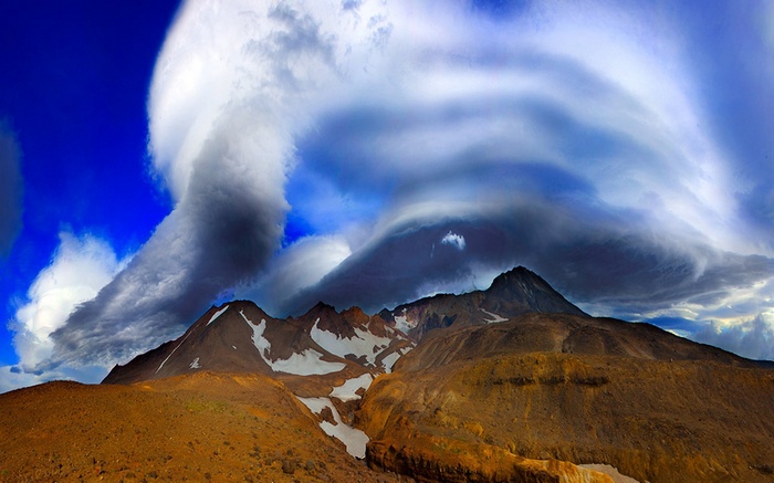 Lenticular clouds over mountains