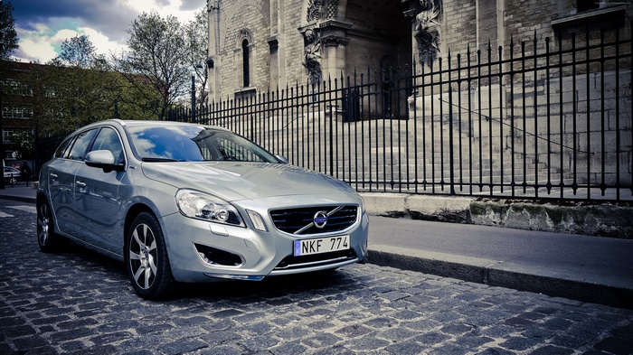 Silver Volvo V60 parked on cobblestone street