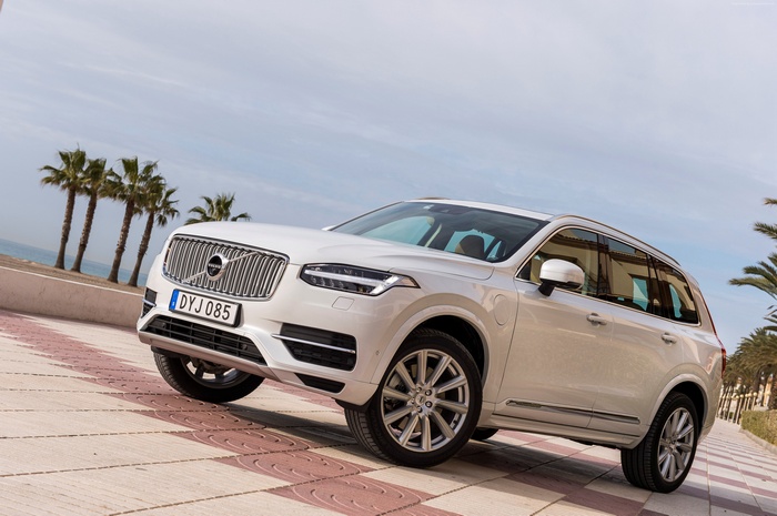 White Volvo XC90 Hybrid SUV on a tiled path