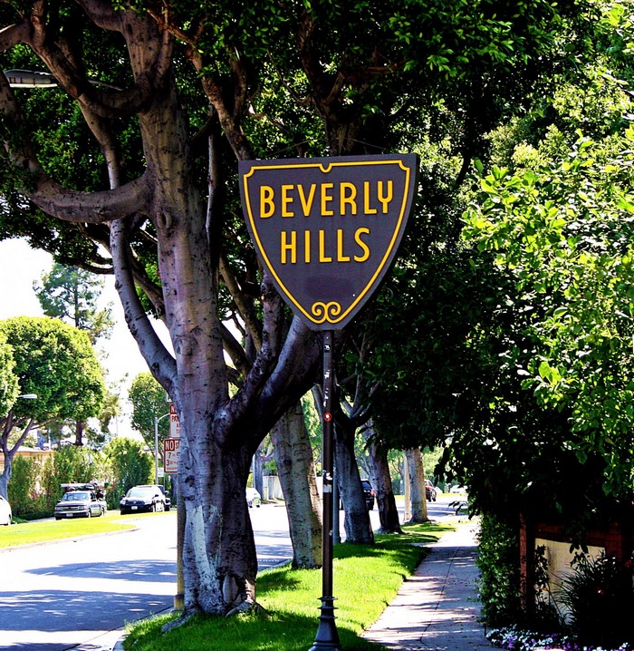 Beverly Hills sign on a tree-lined street
