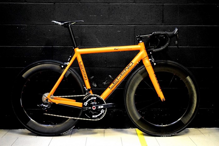 Orange Legend road bicycle with carbon fiber wheels