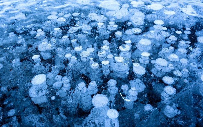 Frozen lake with trapped air bubbles