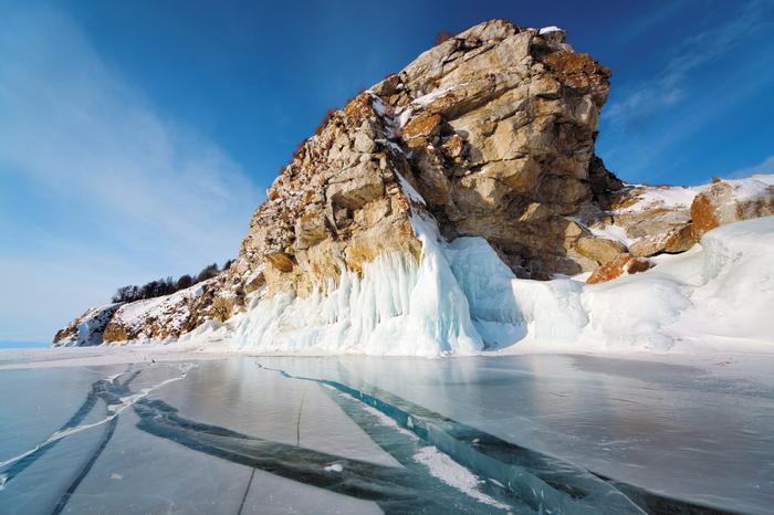Frozen Lake Baikal with Rocky Cliff and Ice Formations