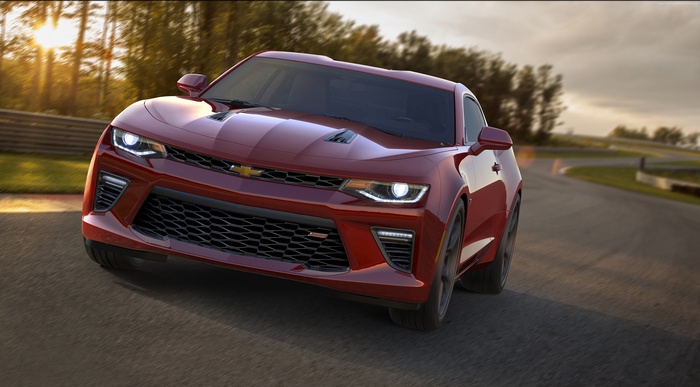Red Chevrolet Camaro SS driving on a race track