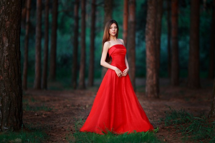 Woman in Elegant Red Dress in Forest