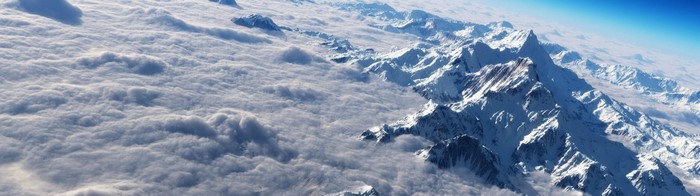 Snow-capped mountains above clouds