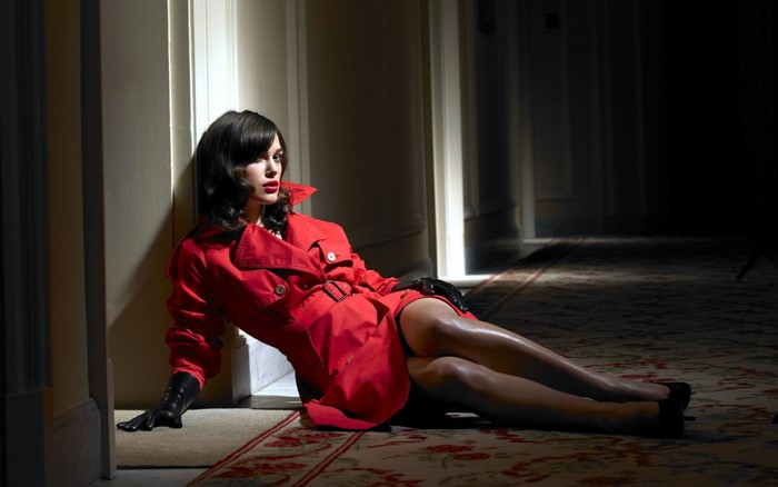 Keira Knightley in Red Trench Coat Sitting Elegantly