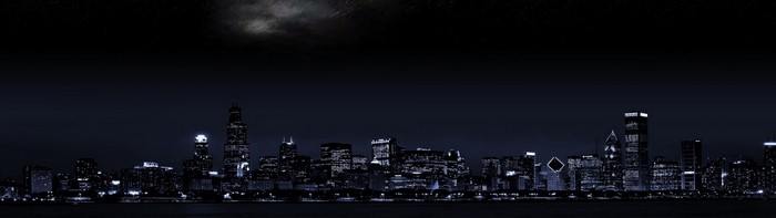 Nighttime Chicago skyline with moonlit clouds