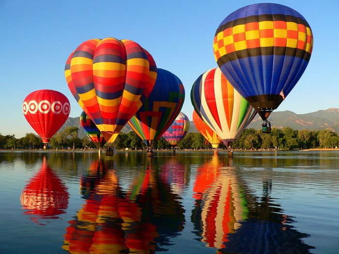 Colorful Hot Air Balloons Over a Calm Lake in Colorado
