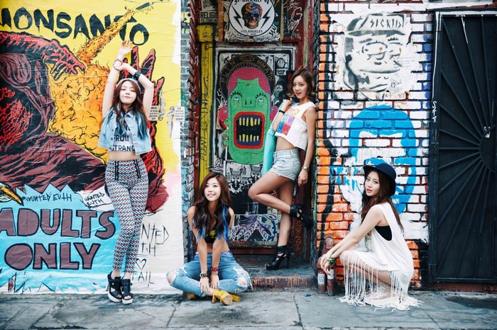 Girls Day K-pop group posing in front of graffiti art