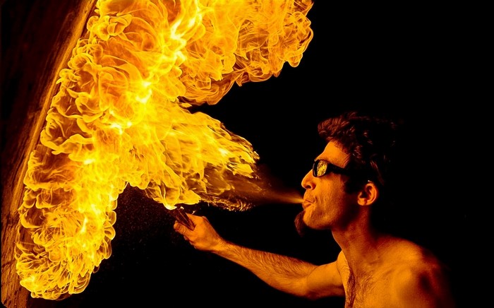 Man blowing fire with sunglasses
