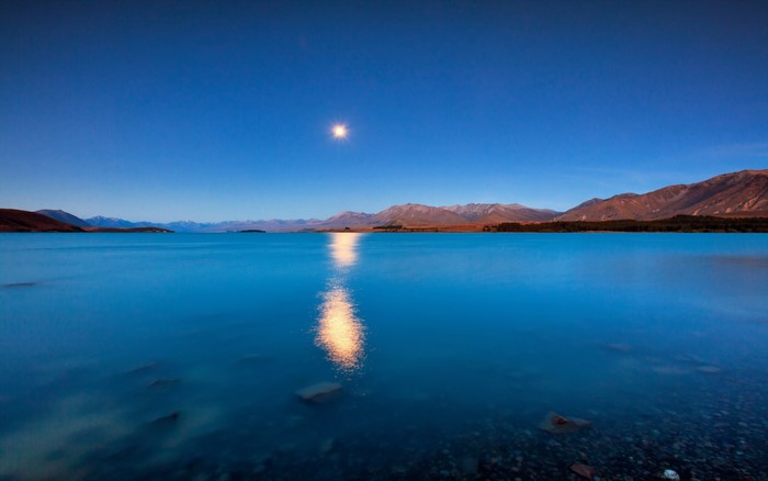 Moonlit lake with mountains and reflection