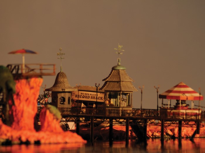 Amusement park pier with record shack and striped umbrella