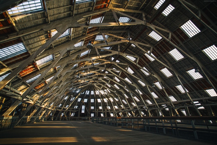 Interior of a wooden building with a domed roof and skylights